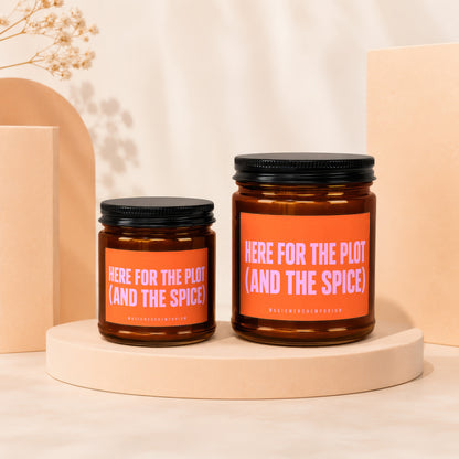 Amber candles with orange labels saying "HERE FOR THE PLOT (AND THE SPICE)".