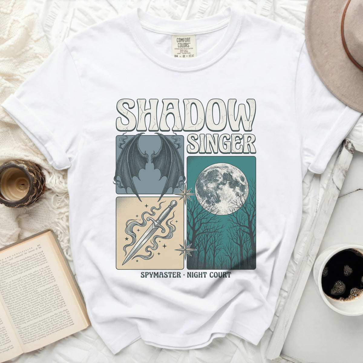 White t-shirt with "SHADOW SINGER" and fantasy art motifs.