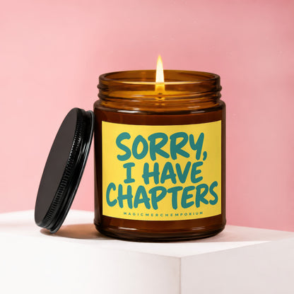 Amber glass candle with lit wick and black lid, featuring yellow label with turquoise text.