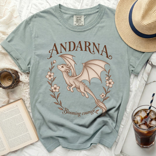 Light blue t-shirt with a dragon graphic and text "ANDARNA Blooming courage".