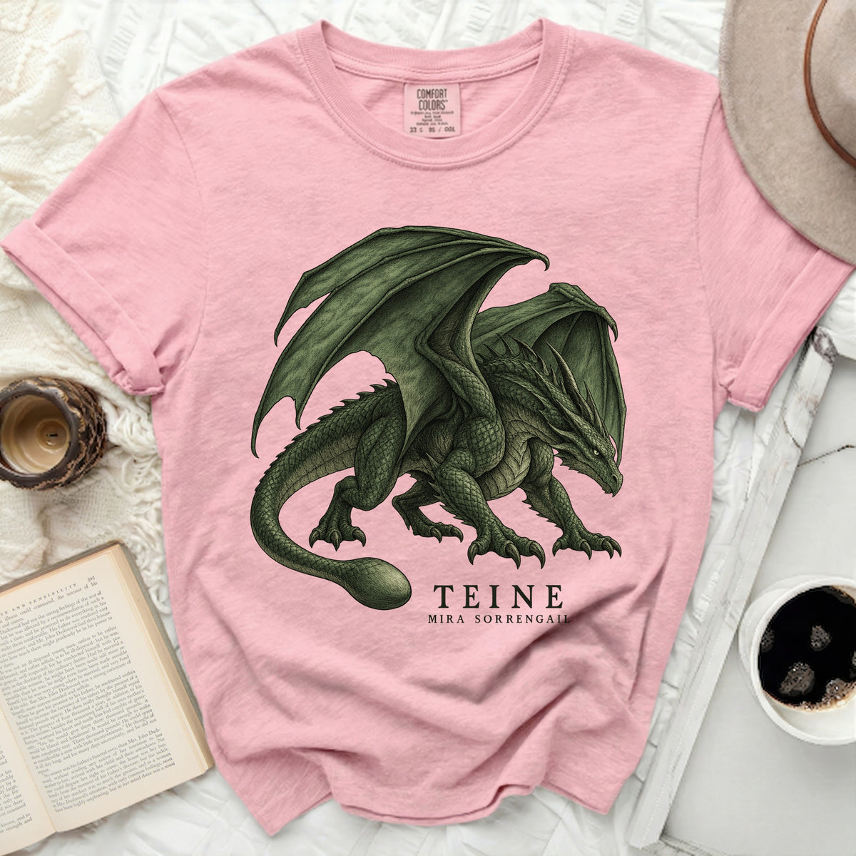 Pink t-shirt with green dragon graphic and text "TEINE MIRA SORRENGALL".