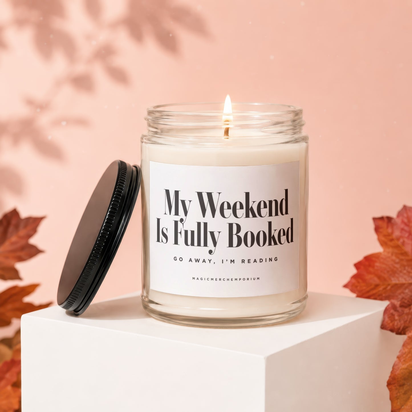 Candle with a lit wick and label reading "My Weekend Is Fully Booked".