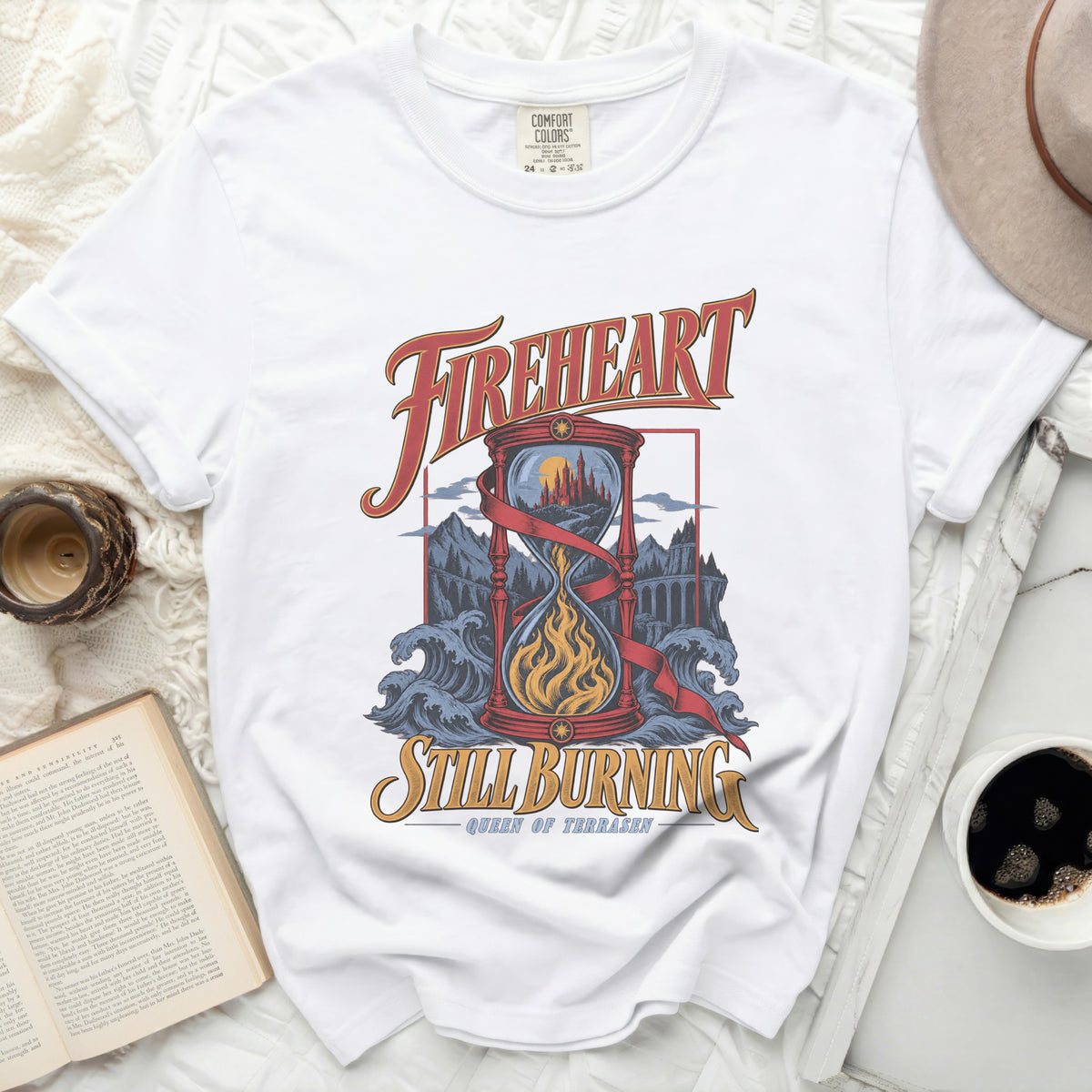 White t-shirt with "FIREHEART STILL BURNING QUEEN OF TERRASEN" graphic.
