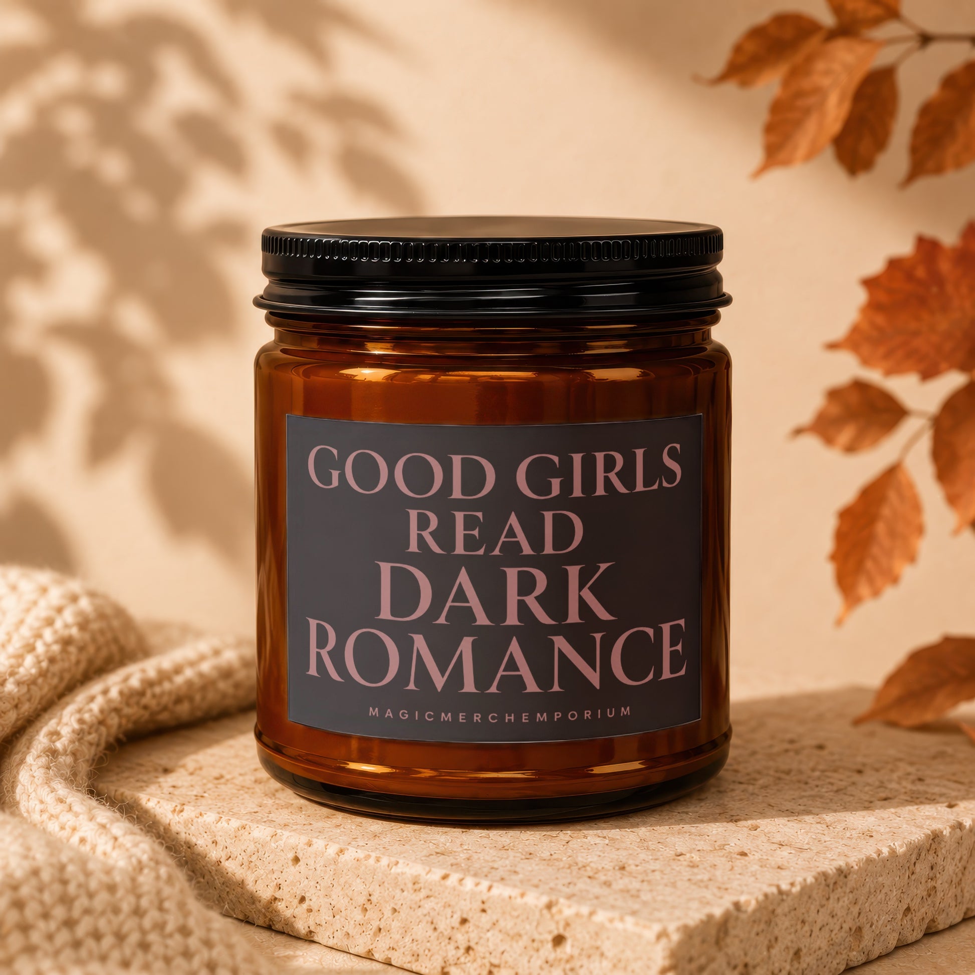 Amber candle with "GOOD GIRLS READ DARK ROMANCE" text on label.