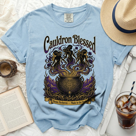 Light blue t-shirt with "Cauldron Blessed Nesta Archeron - Made in the Dark" graphic.
