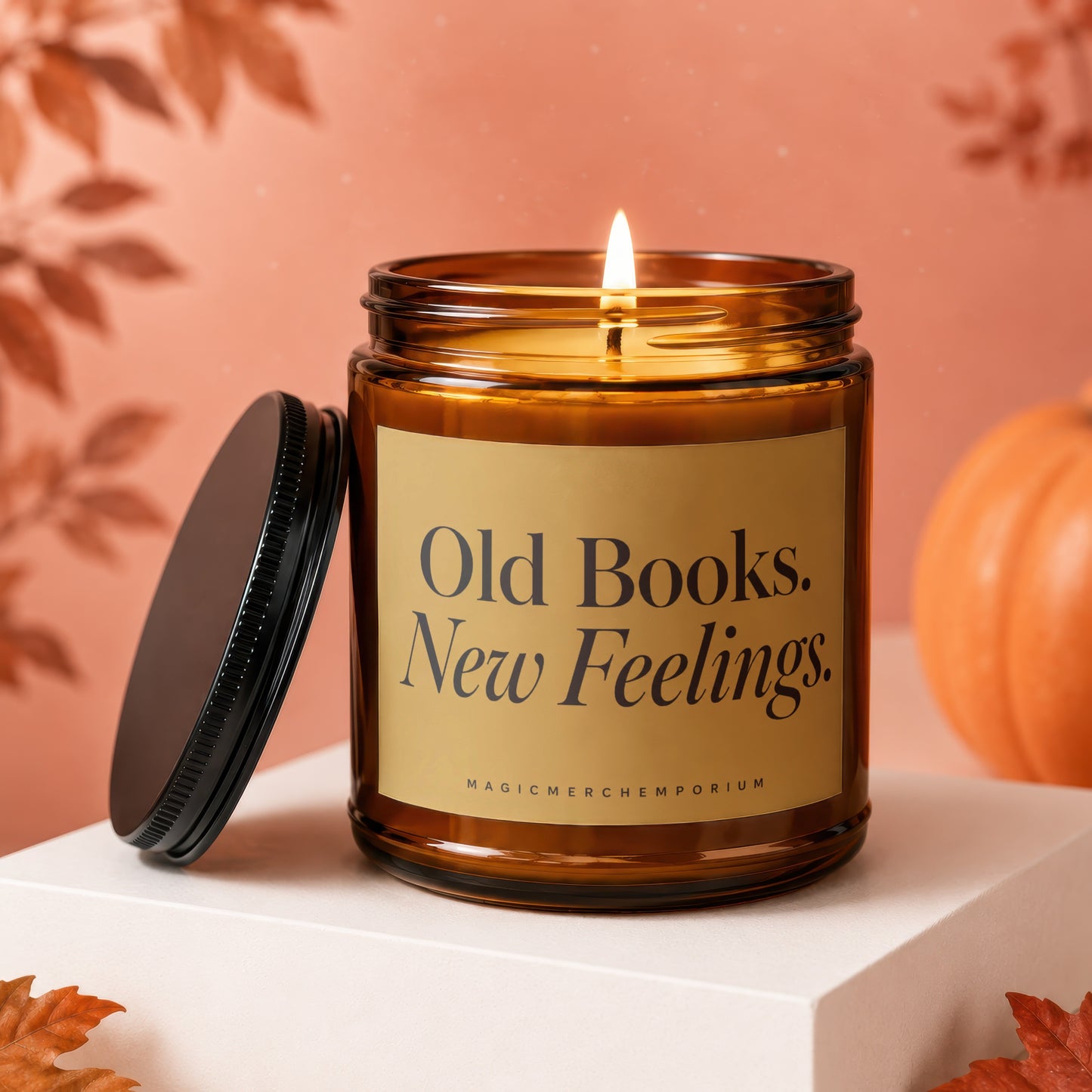 Lit amber glass candle with "Old Books. New Feelings." label, lid removed.