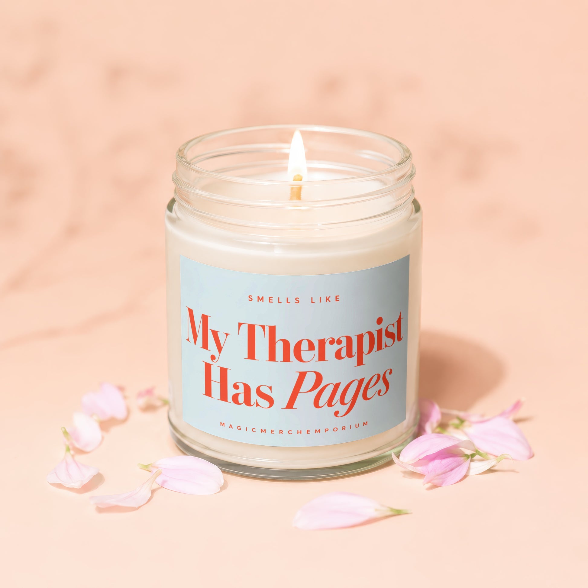 Scented candle with label text "My Therapist Has Pages" and "MagicMerchEmporium".