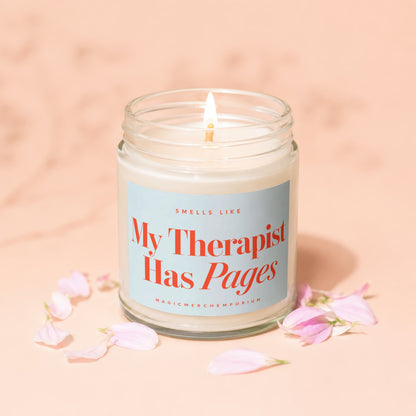 Scented candle with label text "My Therapist Has Pages" and "MagicMerchEmporium".