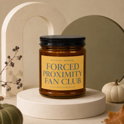 Glass jar candle with label: "OFFICIAL MEMBER: FORCED PROXIMITY FAN CLUB".