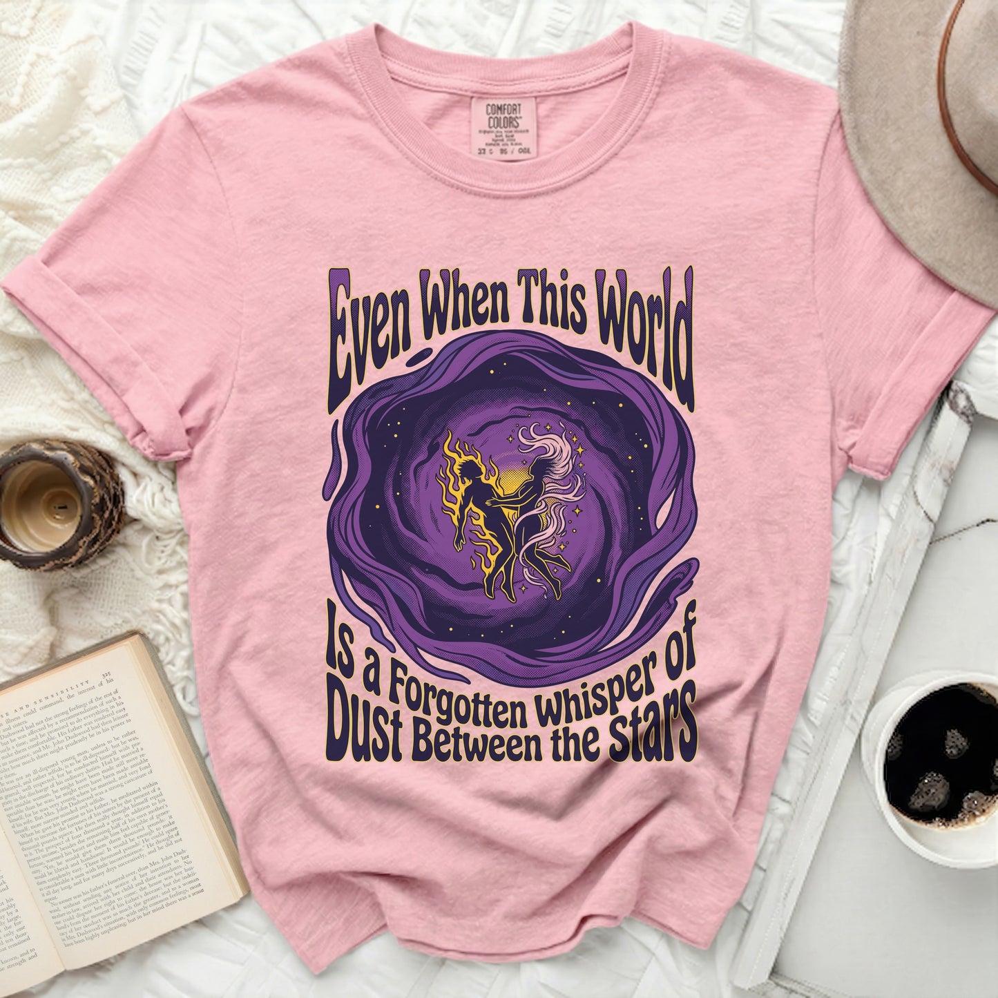 Pink t-shirt with purple and yellow cosmic illustration and text.