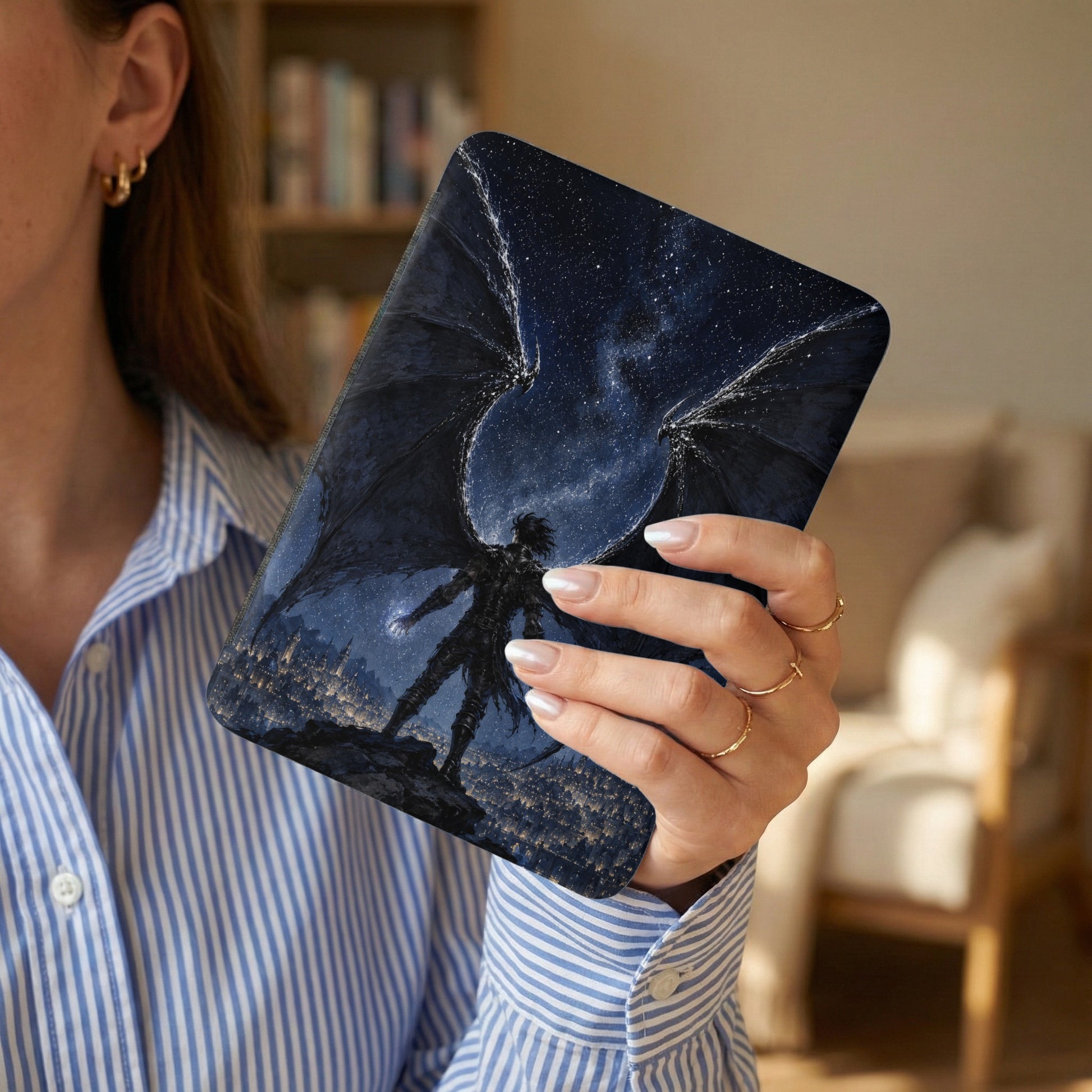 E-reader cover with dark angel against a starry sky and city.