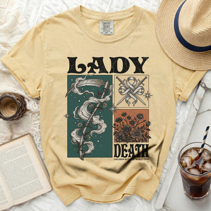 Yellow t-shirt with "LADY DEATH" graphic, scythe, crossed swords, and flowers.