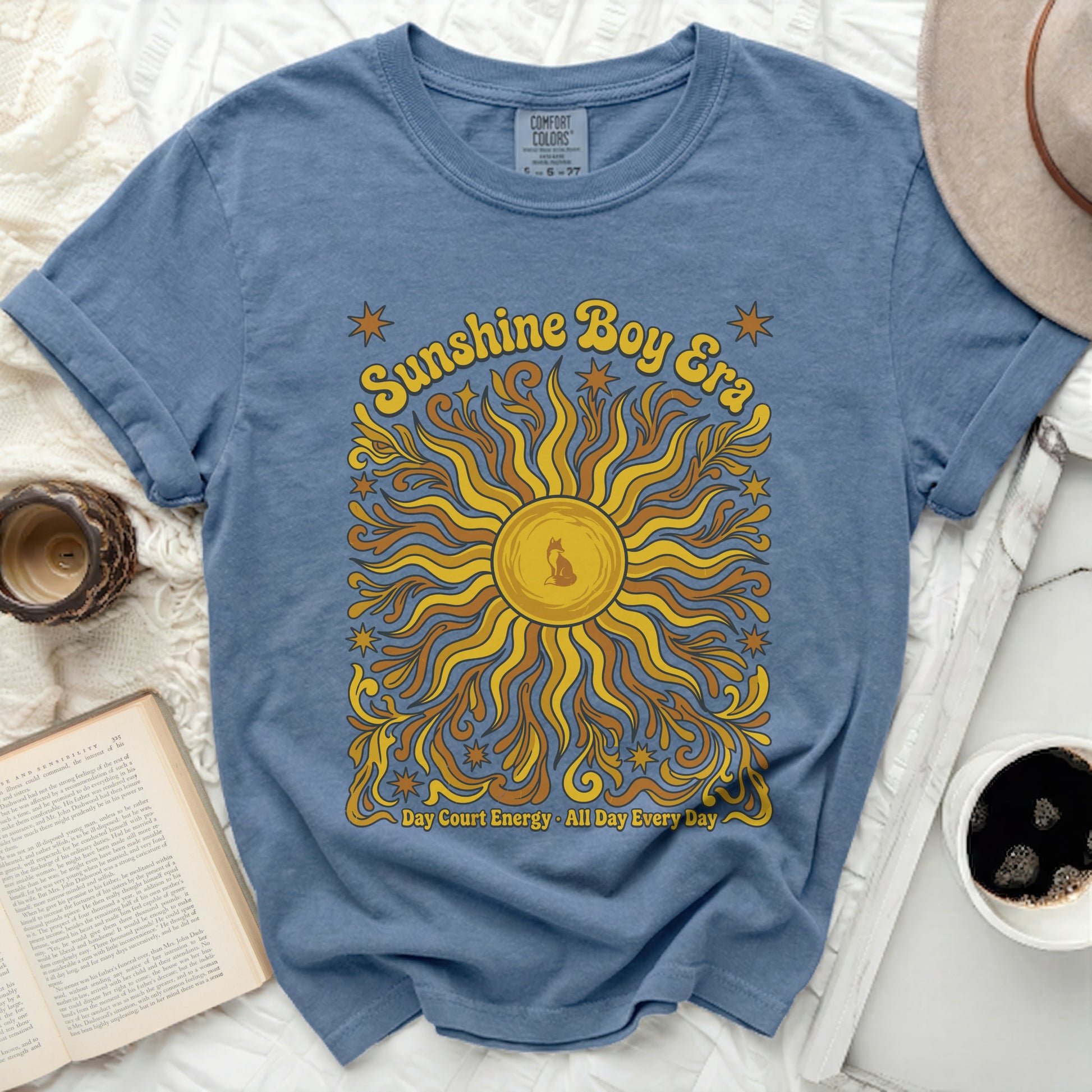 Blue t-shirt with "Sunshine Boy Era" and sun graphic.
