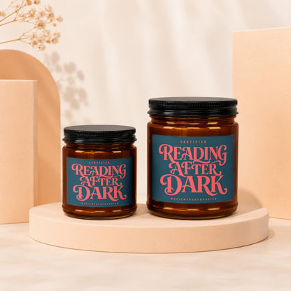 Two amber glass candles with black lids and "Reading After Dark" labels.