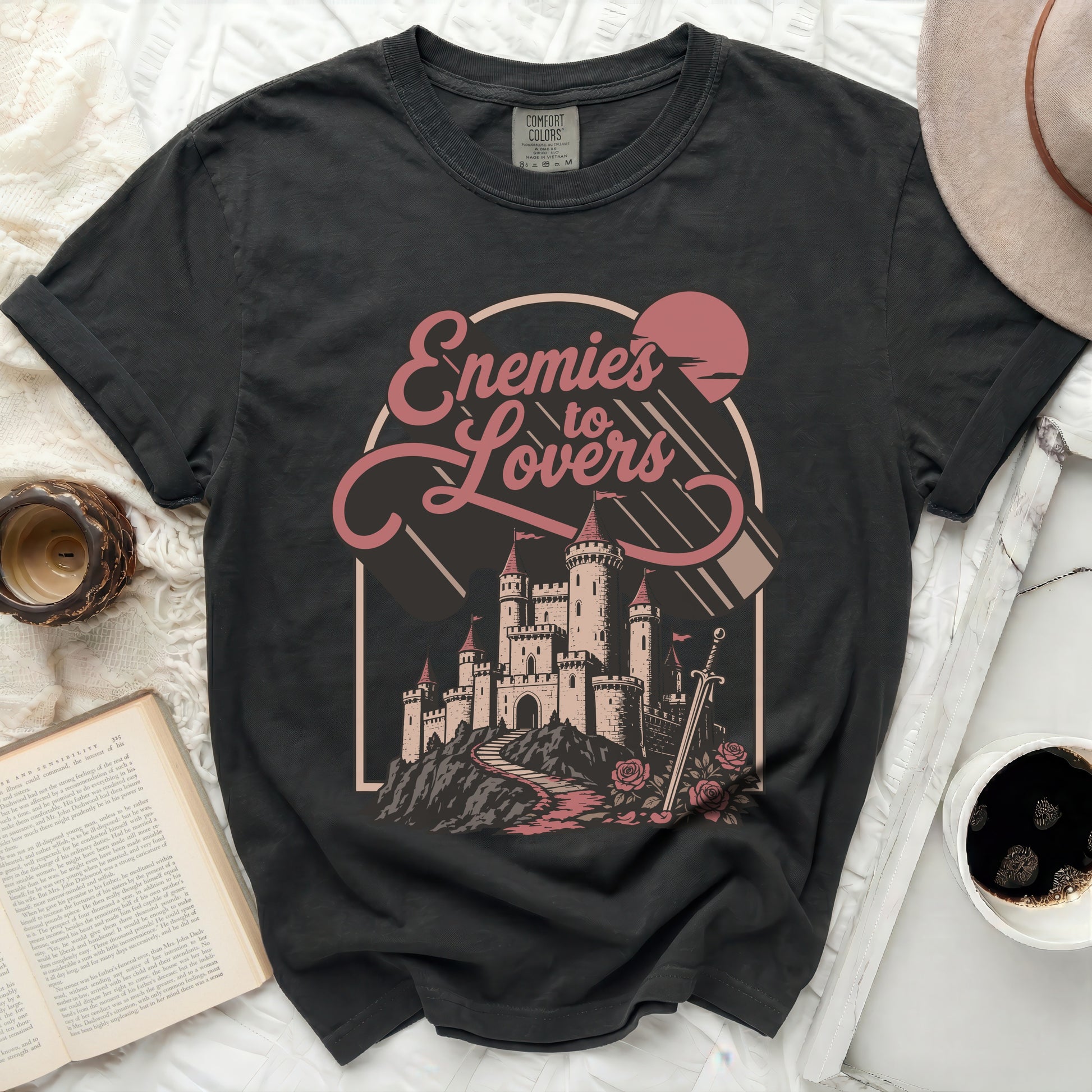 Black Comfort Colors t-shirt with "Enemies to Lovers" castle graphic.