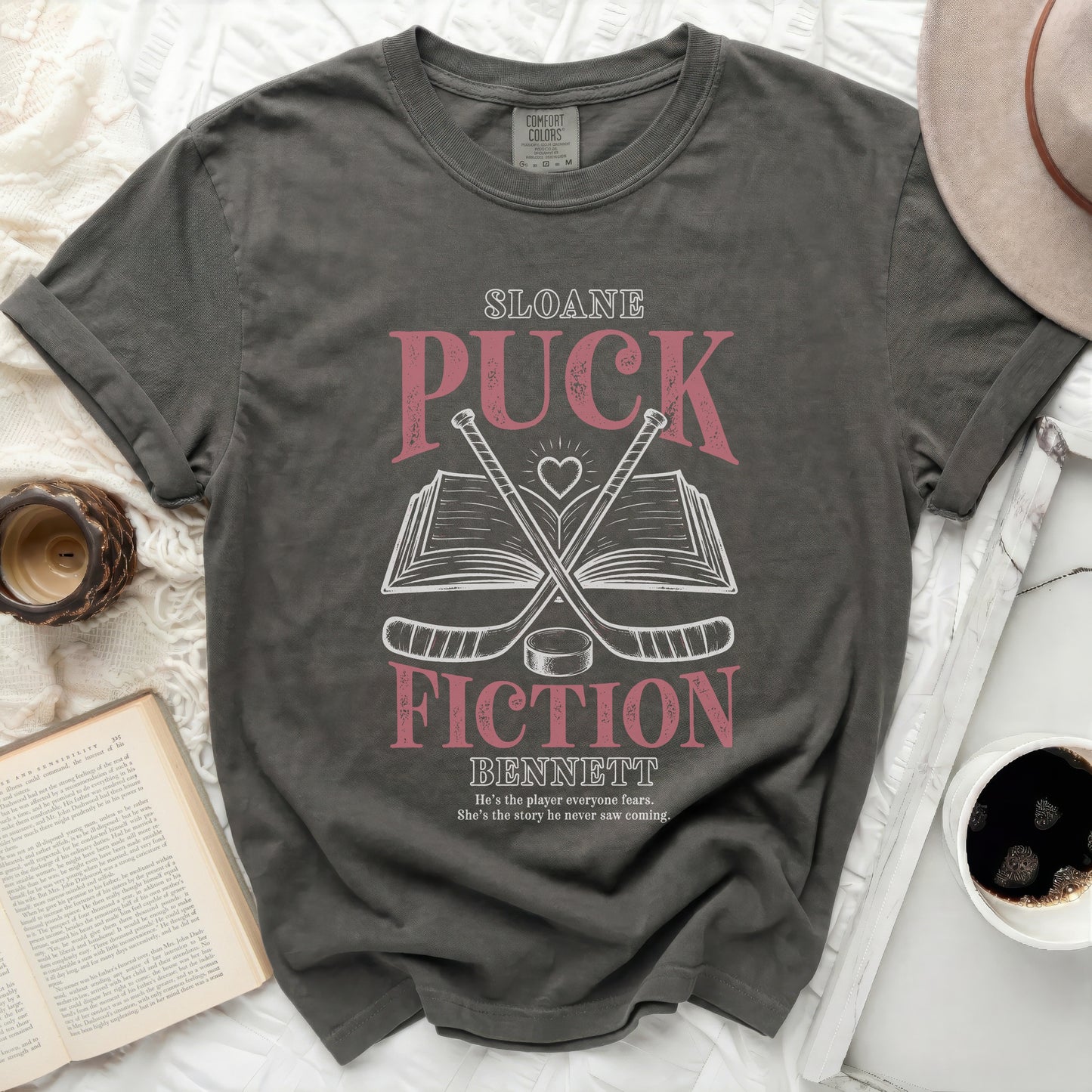 Dark grey t-shirt with "Sloane Fiction Bennett" title and hockey sticks.