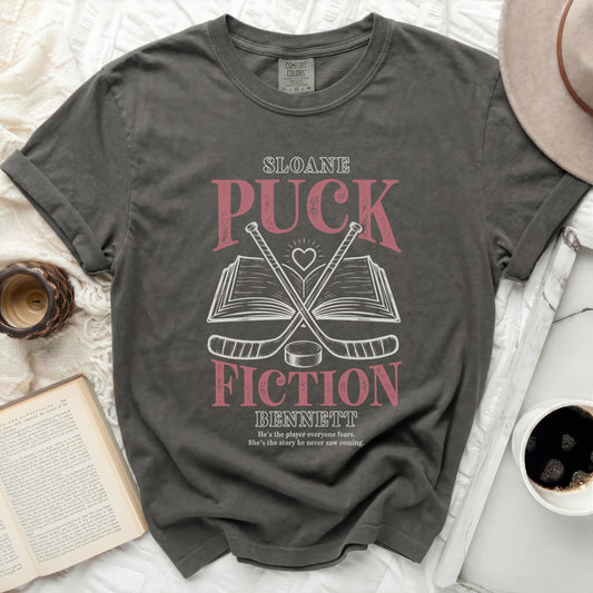 Dark grey t-shirt with "Sloane Fiction Bennett" title and hockey sticks.