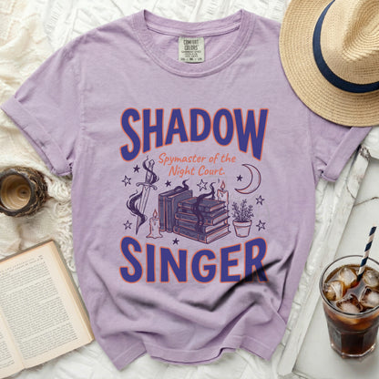 Purple t-shirt with "Shadow Spymaster of the Night Court. SINGER" graphic.