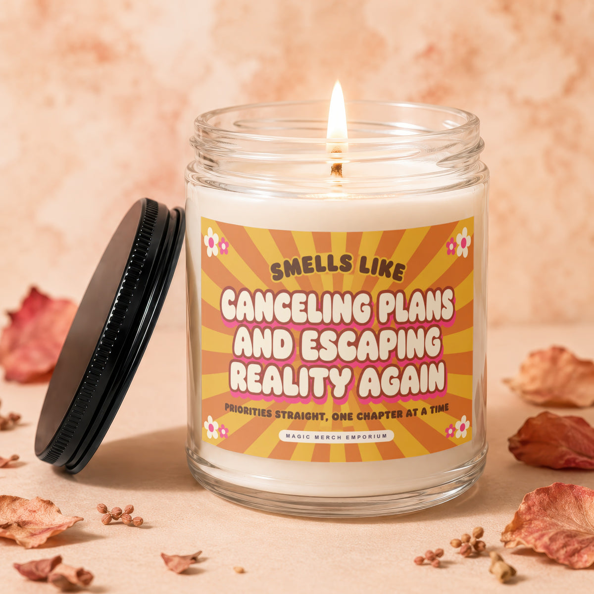 A lit, scented candle in a glass jar with a label reading Canceling Plans and Escaping Reality Again.
