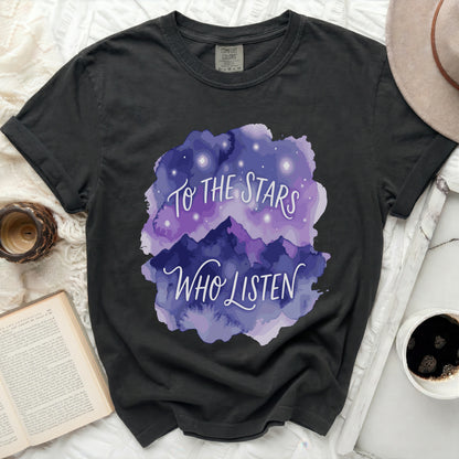 Dark t-shirt with purple watercolor mountains and "To the Stars Who Listen" text.