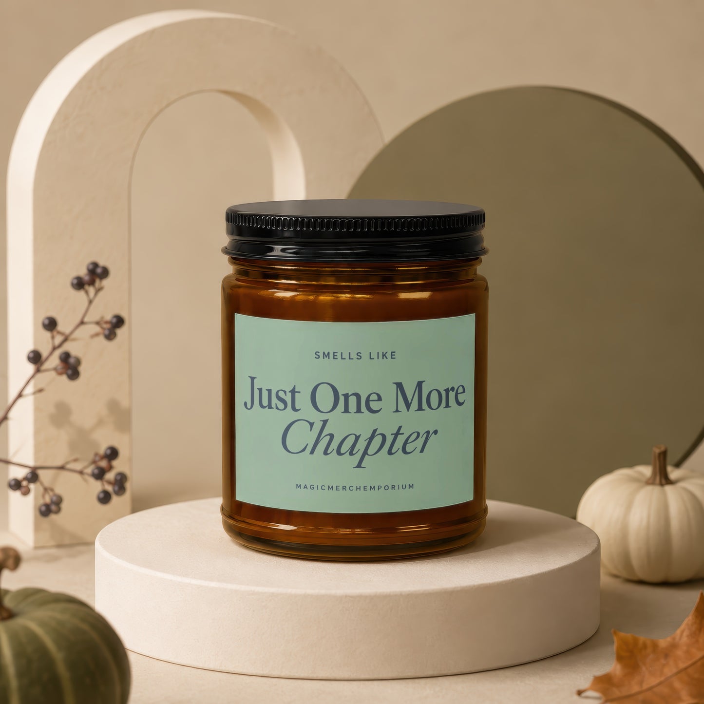 Amber jar candle with black lid, "Just One More Chapter" text on light green label.
