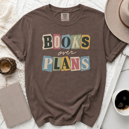 Brown t-shirt with "BOOKS over PLANS" in torn letter graphic.