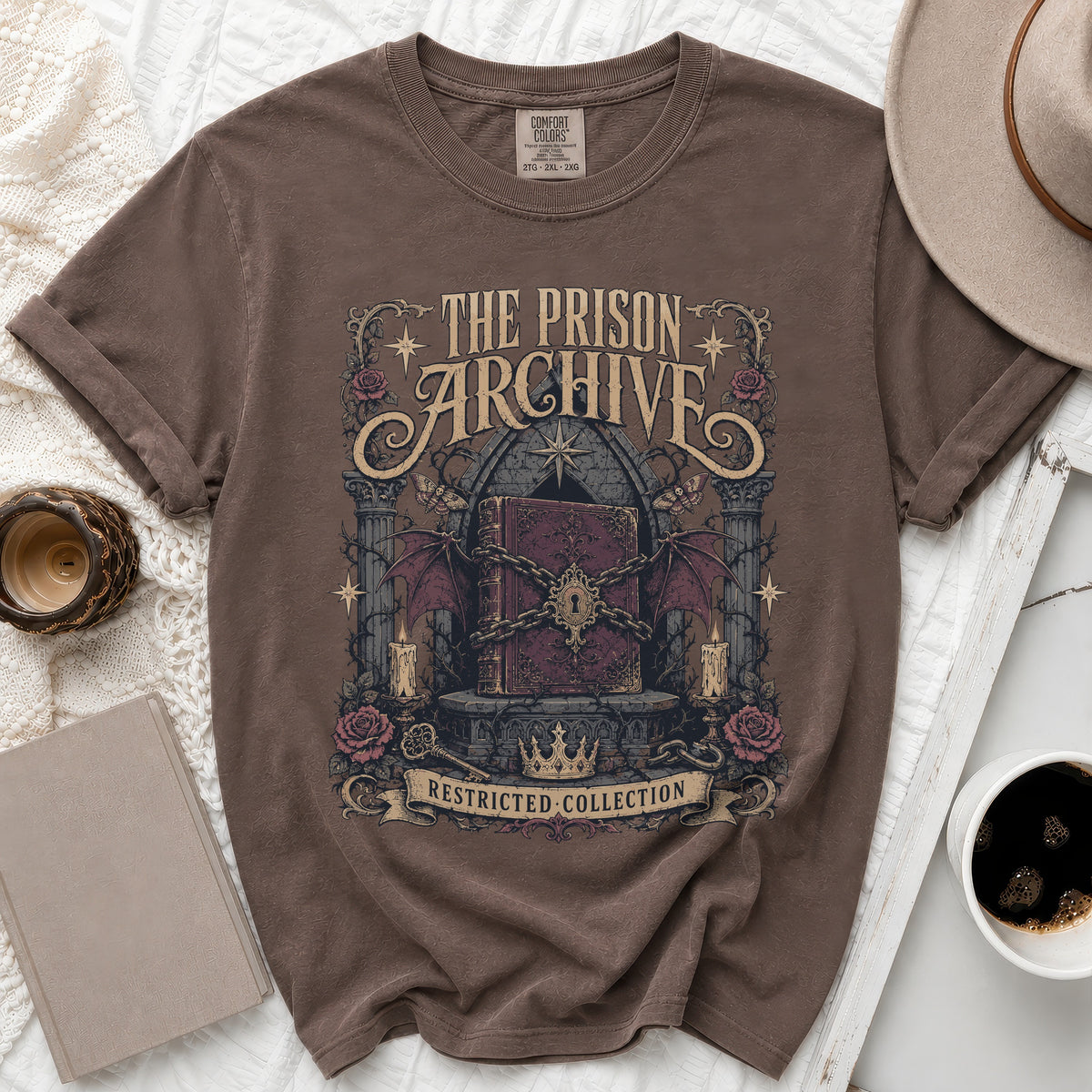 T-shirt with "The Prison Archive" and "Restricted Collection" text, featuring a locked book.