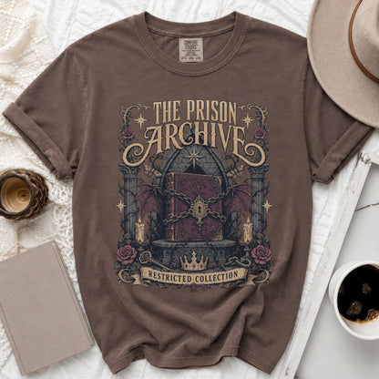 T-shirt with "The Prison Archive" and "Restricted Collection" text, featuring a locked book.