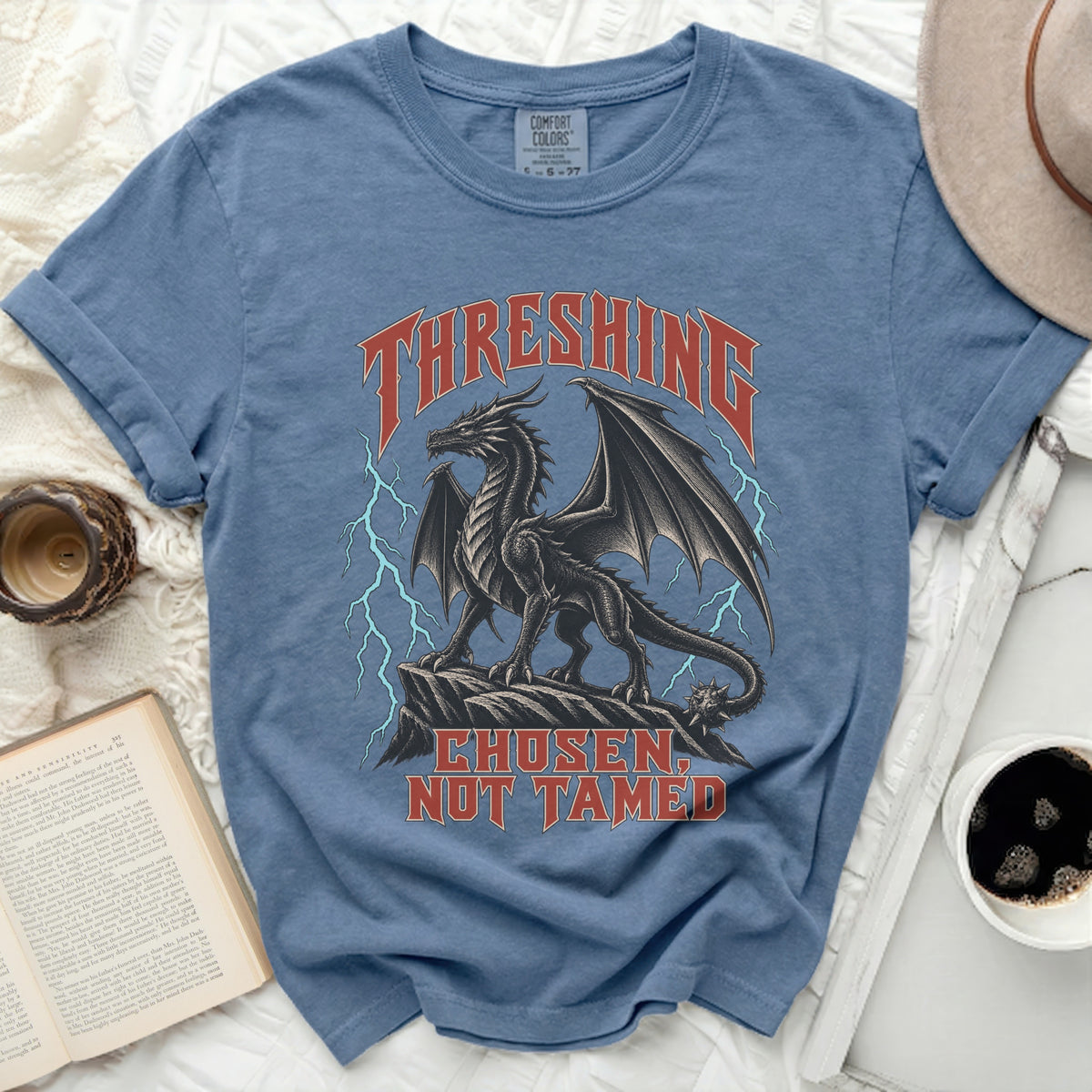 Blue t-shirt with black dragon graphic and text "THRESSHING CHOSEN, NOT TAMED"
