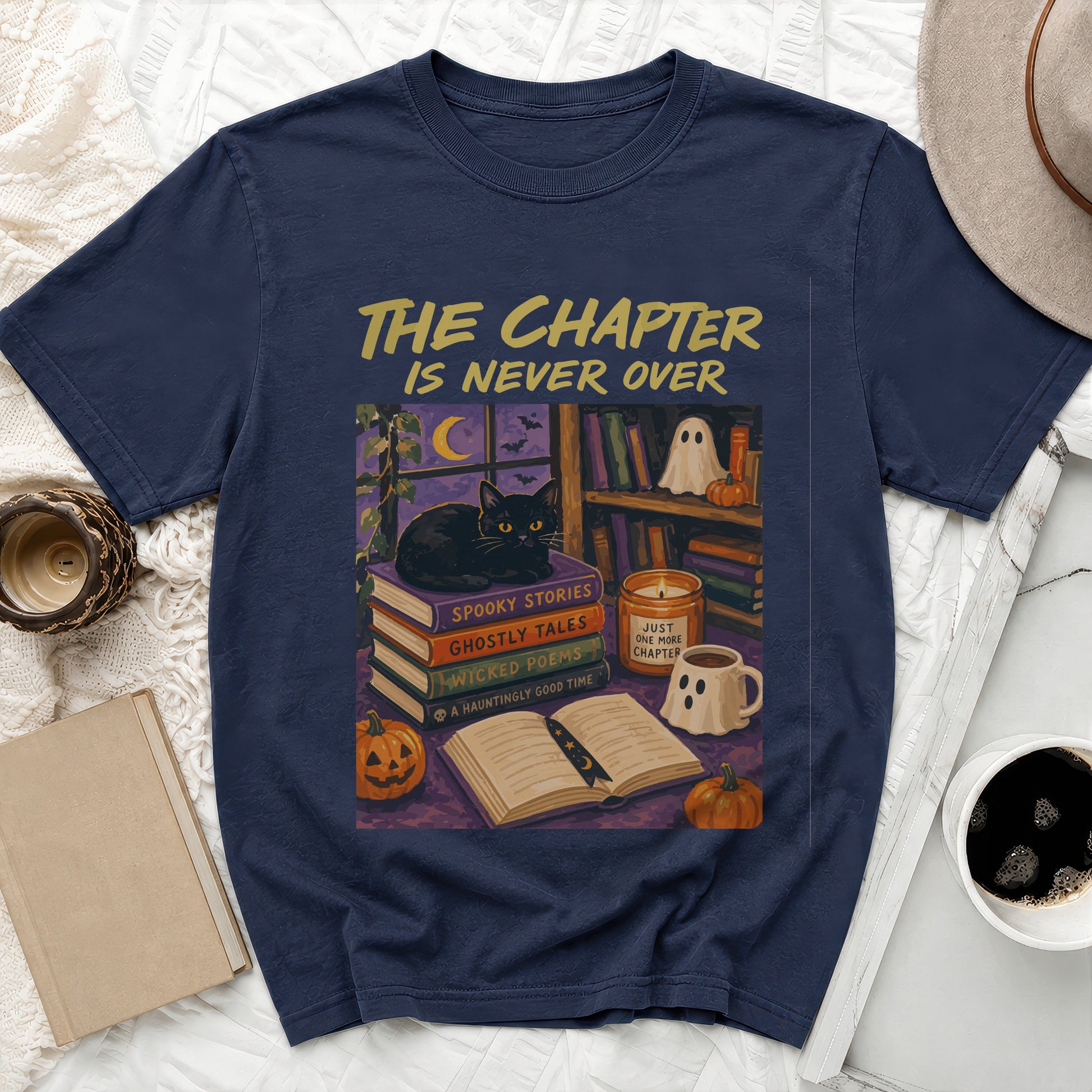 Navy t-shirt with "The Chapter is Never Over" and a spooky book scene.