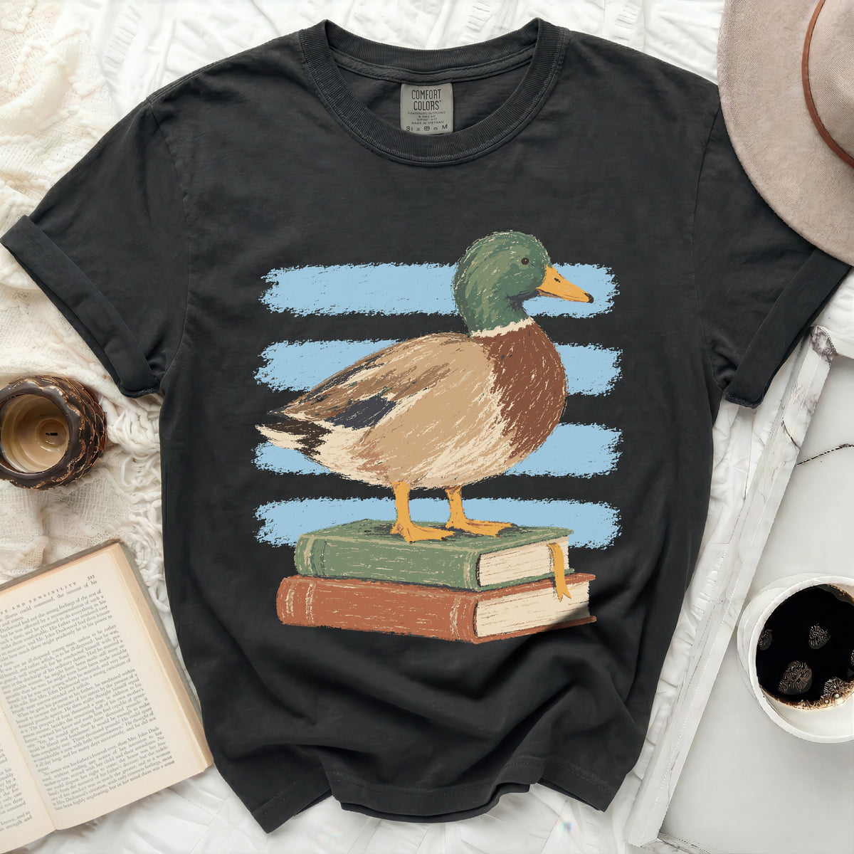 Black t-shirt with a mallard duck standing on stacked books.