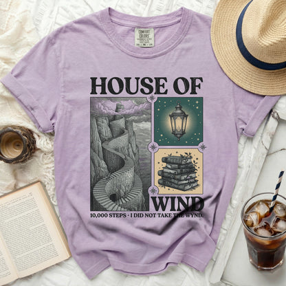 Lavender shirt with "House of Wind" graphic, stairs, lantern, and books.