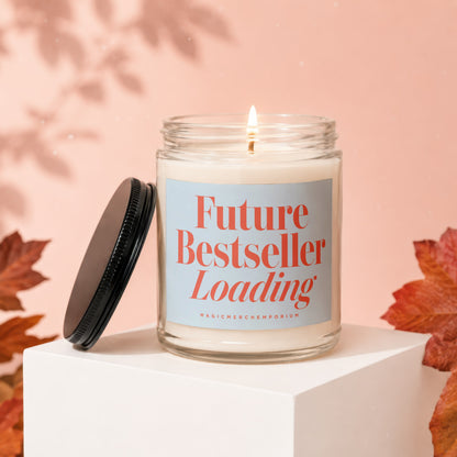 Candle in glass jar with label reading "Future Bestseller Loading".