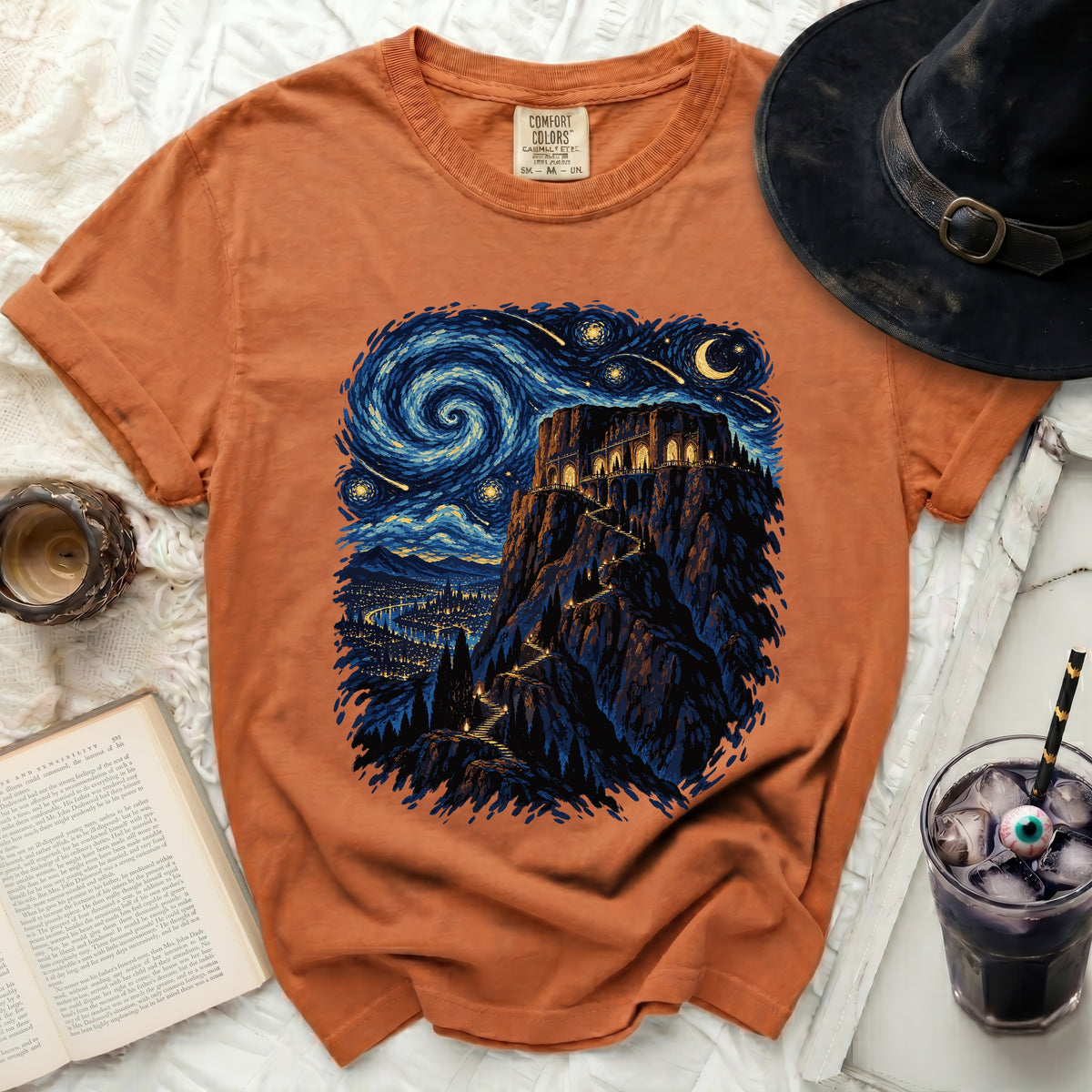 Orange t-shirt with a dark, starry night castle scene.