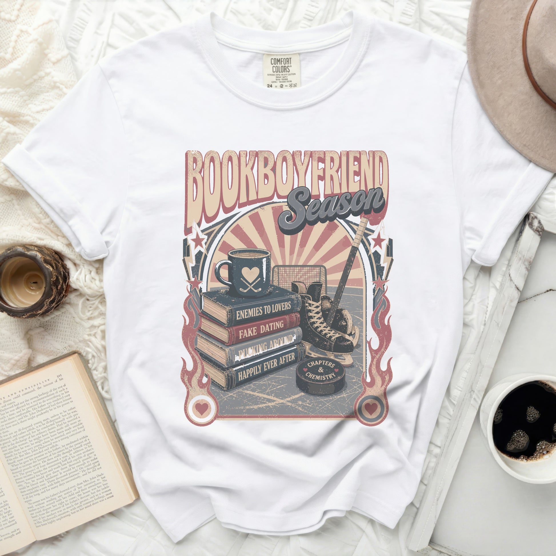 White t-shirt with "BOOKBOYFRIEND SEASON" graphic featuring books, hockey, and quotes.