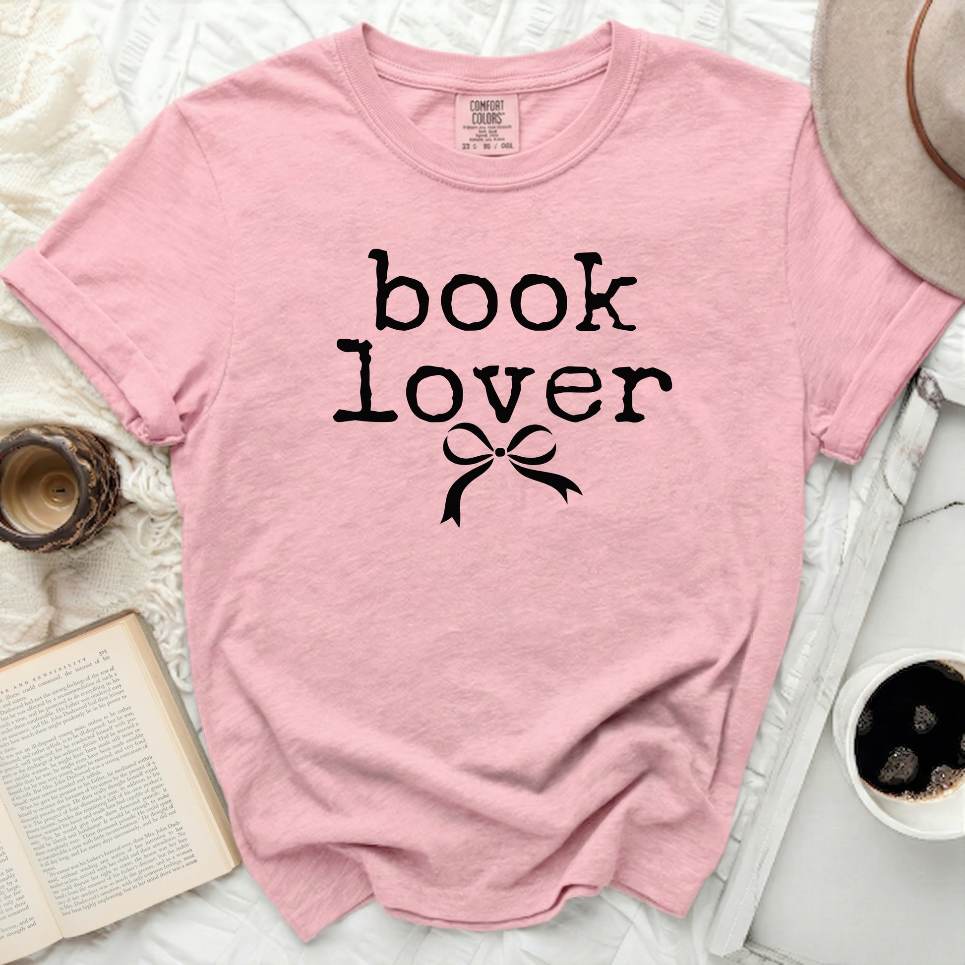 Pink t-shirt with black "book lover" text and bow graphic.