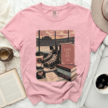 Pink t-shirt with hockey ice skates, books, coffee, and text.