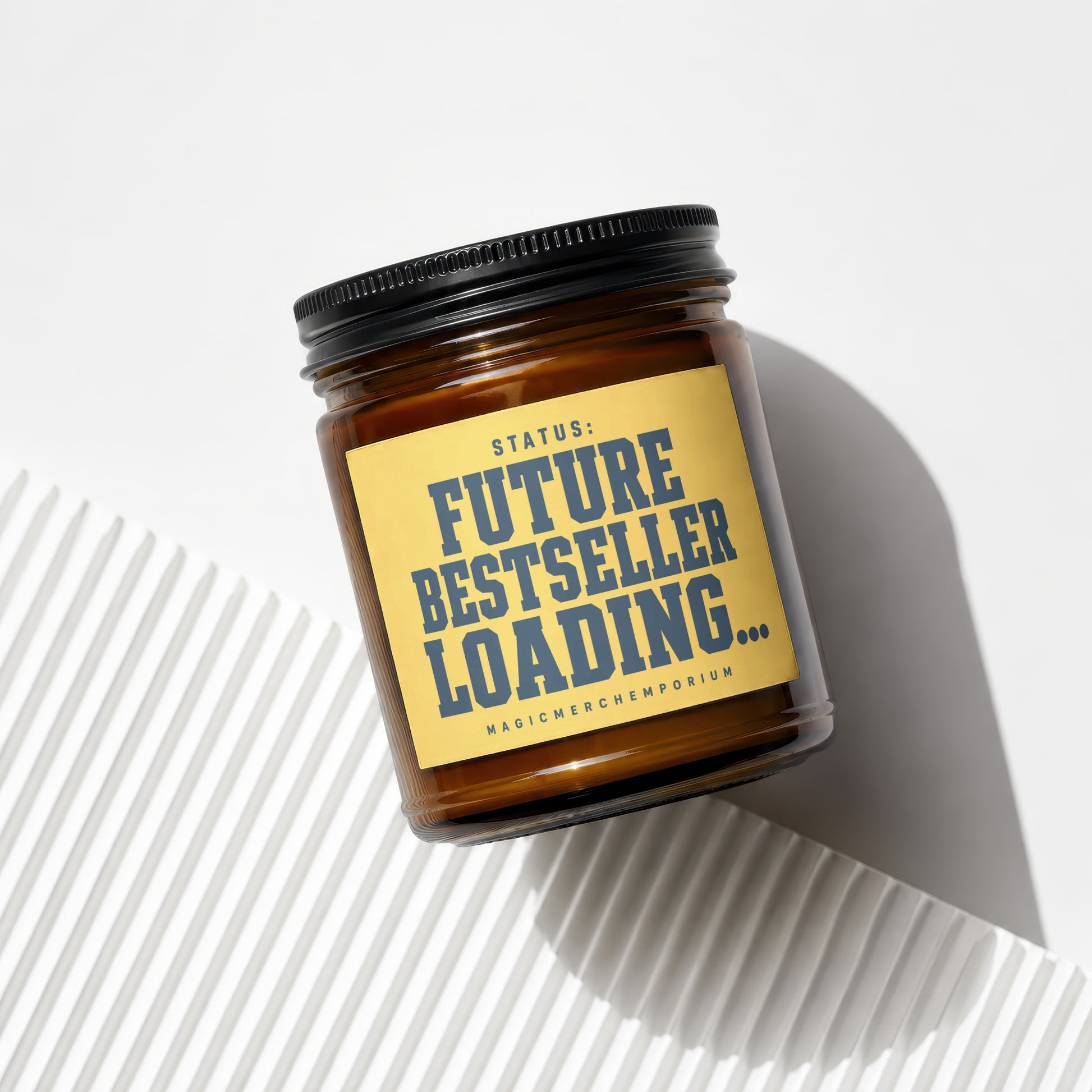 Amber jar candle with yellow label: "STATUS: FUTURE BESTSELLER LOADING..."