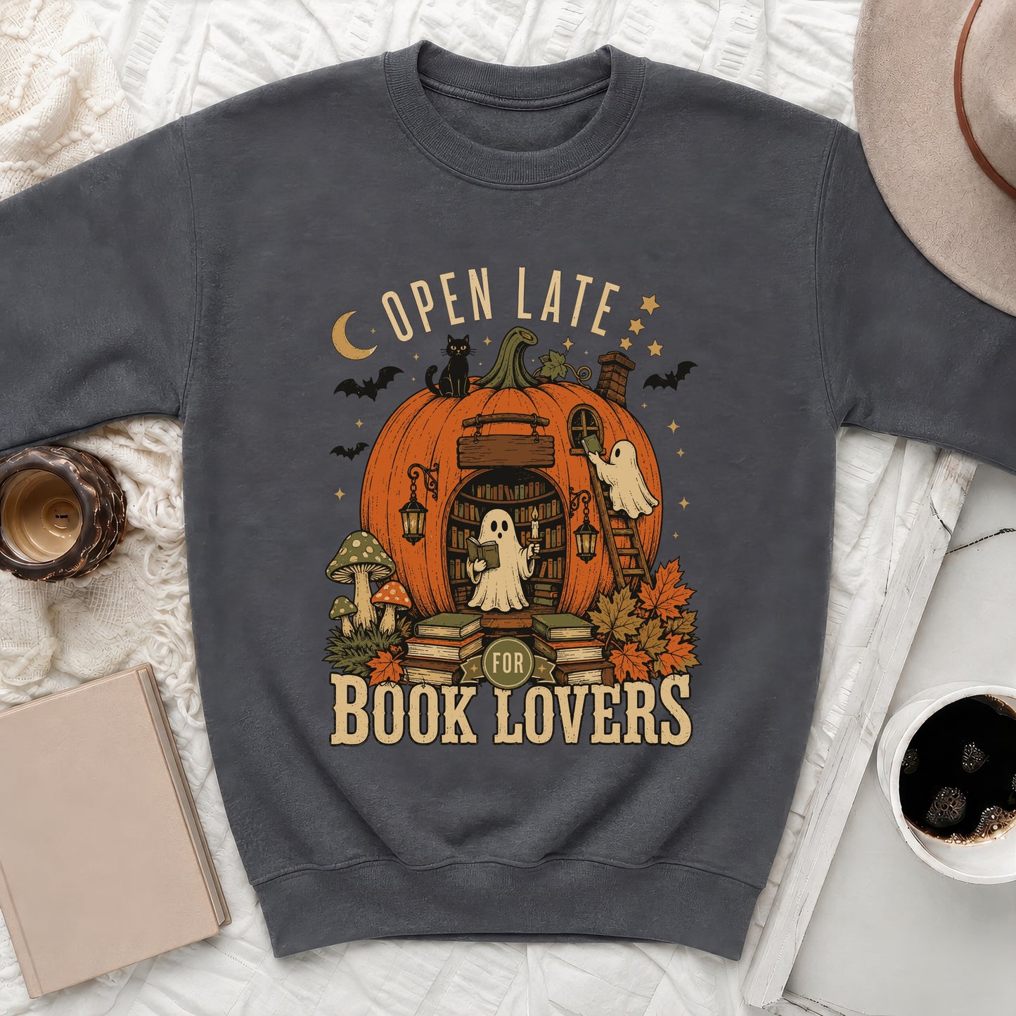 Dark gray sweatshirt with "Open Late for Book Lovers" graphic featuring a pumpkin library and ghost.