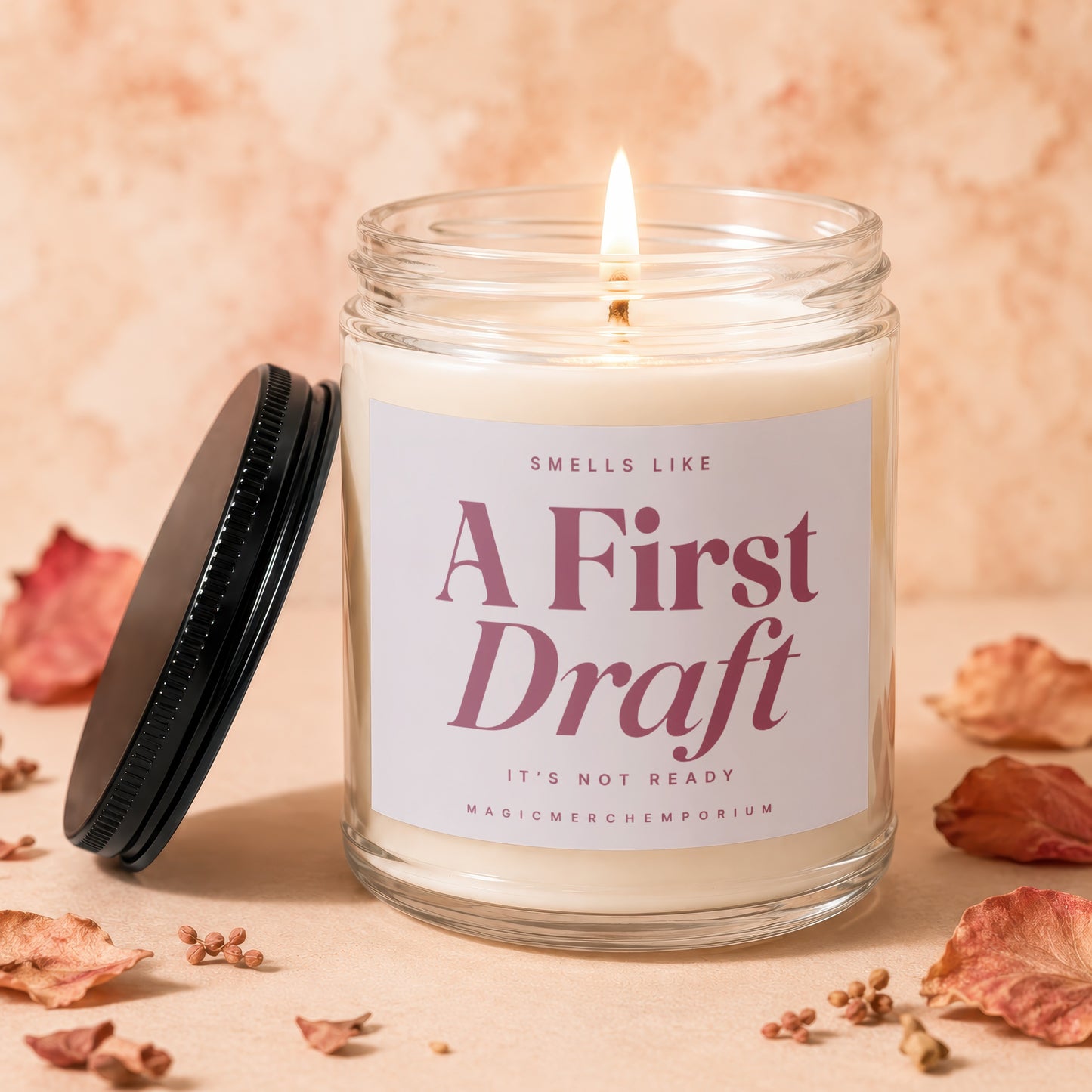 Candle labeled "A First Draft, It's Not Ready" with a lit wick.