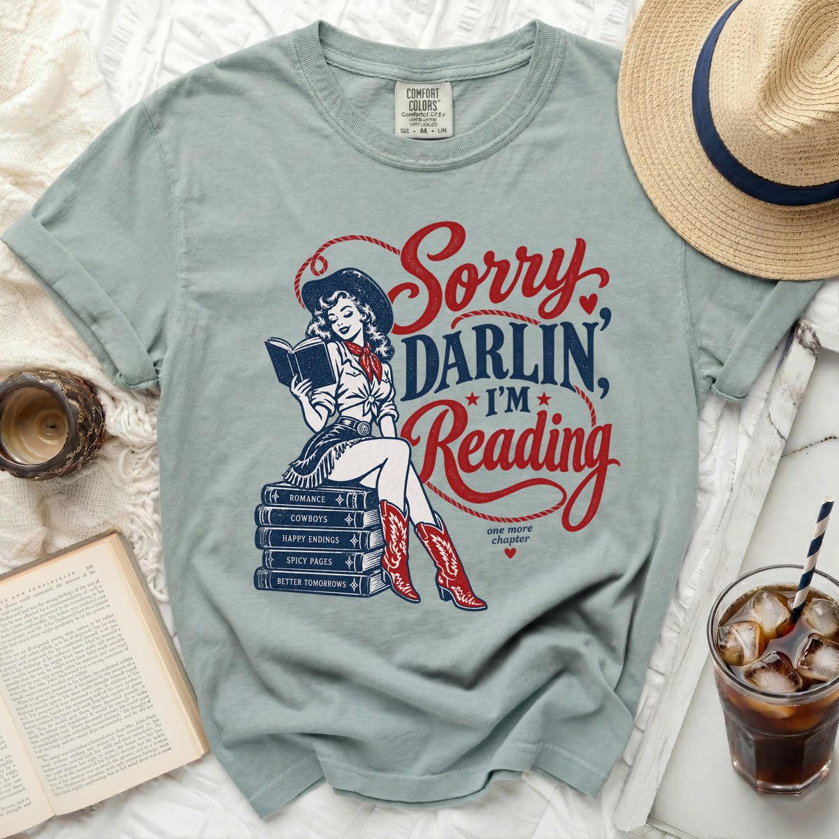 Light green t-shirt with "Sorry Darlin, I'm Reading" graphic.