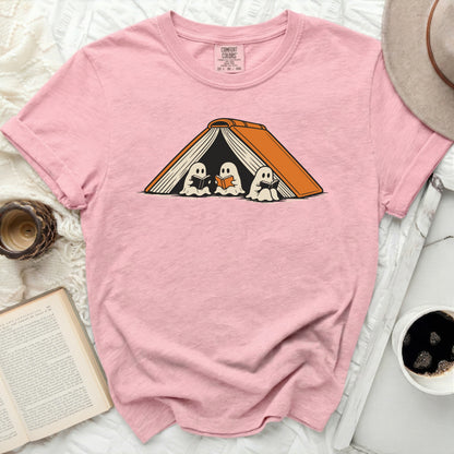 Pink t-shirt with ghosts reading under an open book graphic.