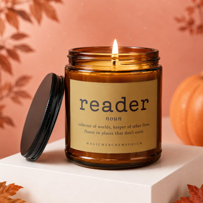Amber glass candle with "reader" definition label, lid off, fall decor.