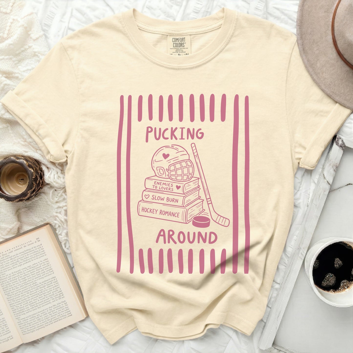 Cream t-shirt with pink hockey romance graphic and text.