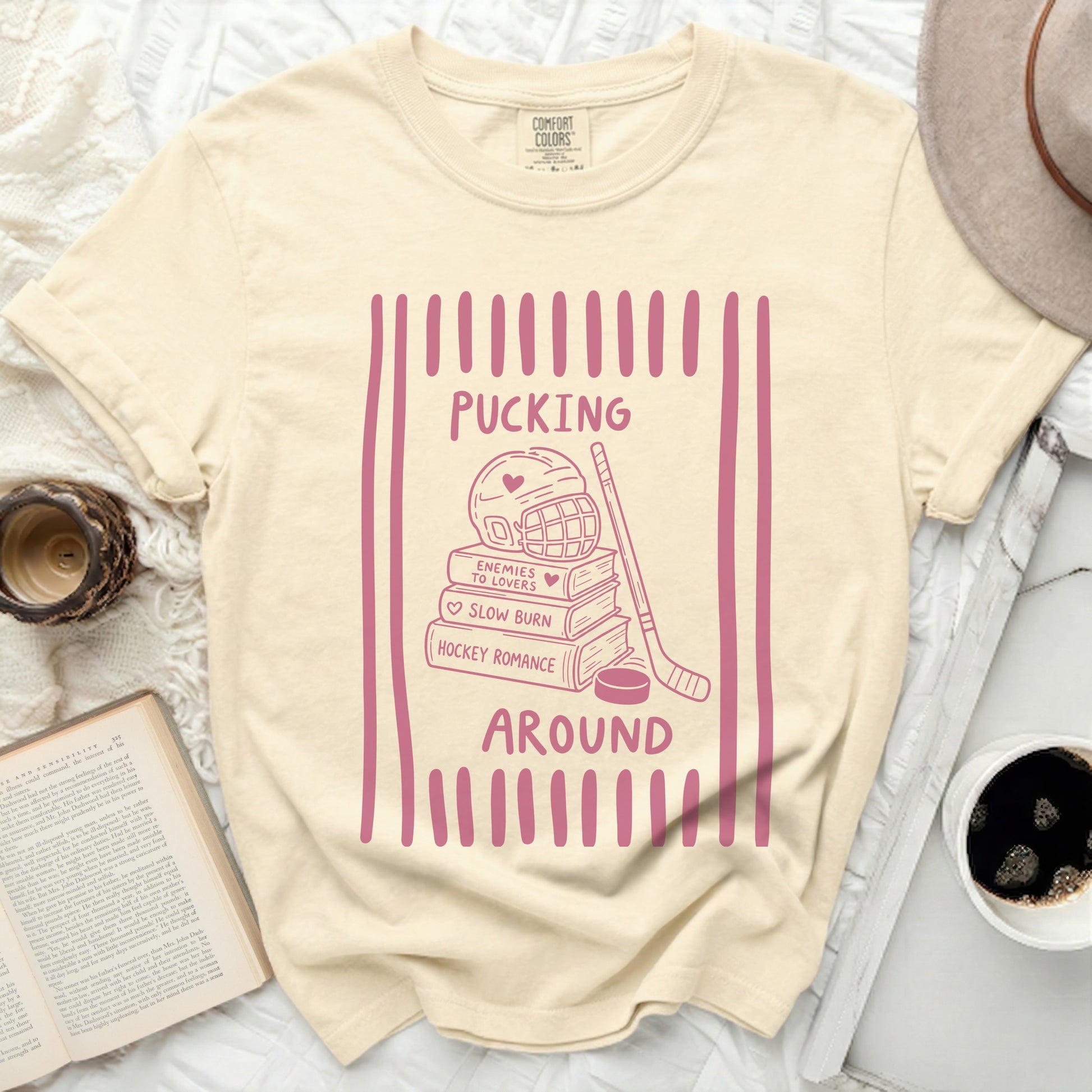 Cream t-shirt with pink hockey romance graphic and text.