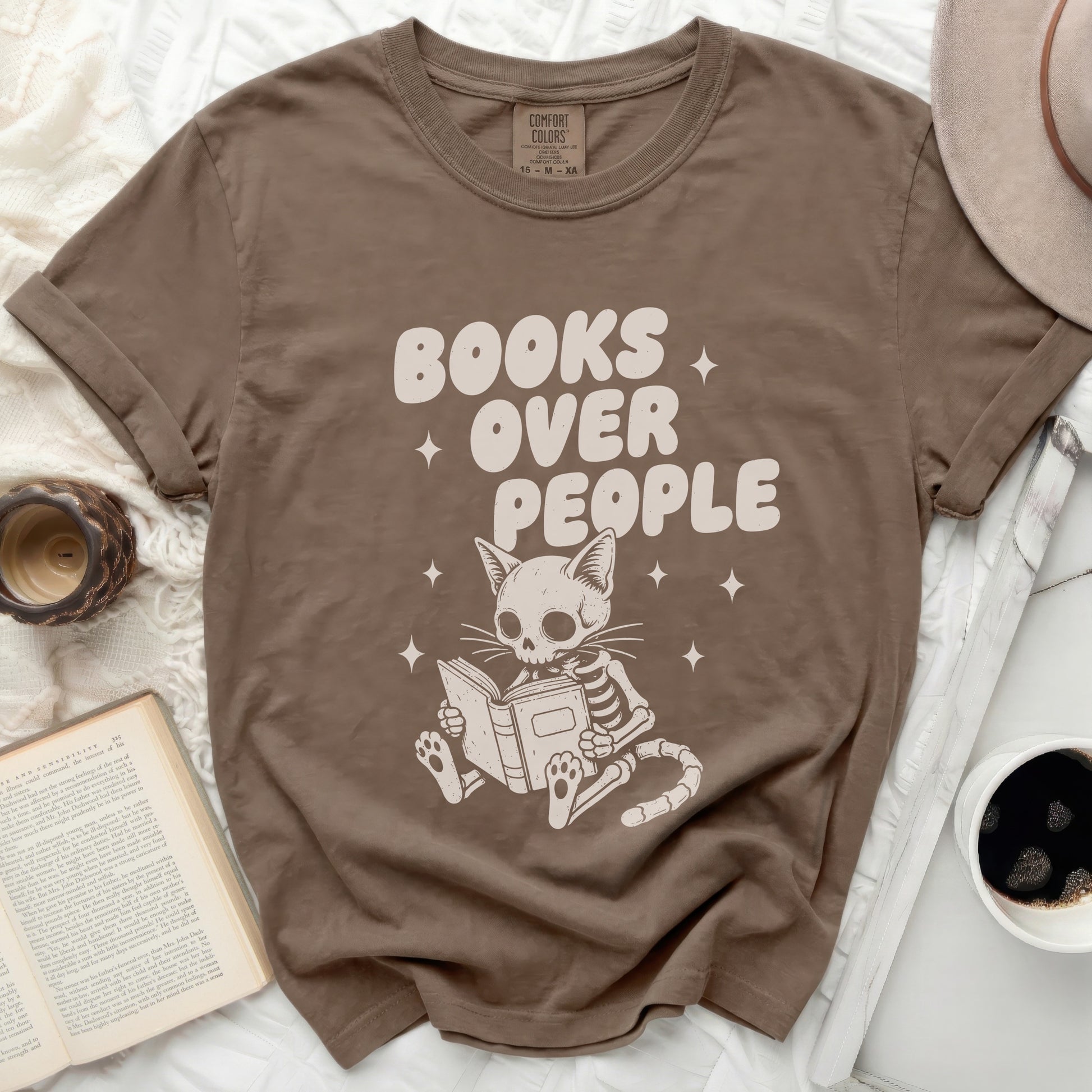 T-shirt with "BOOKS OVER PEOPLE" and a skeleton cat reading a book.