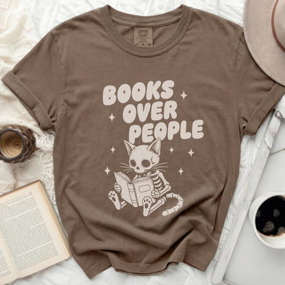 T-shirt with "BOOKS OVER PEOPLE" and a skeleton cat reading a book.