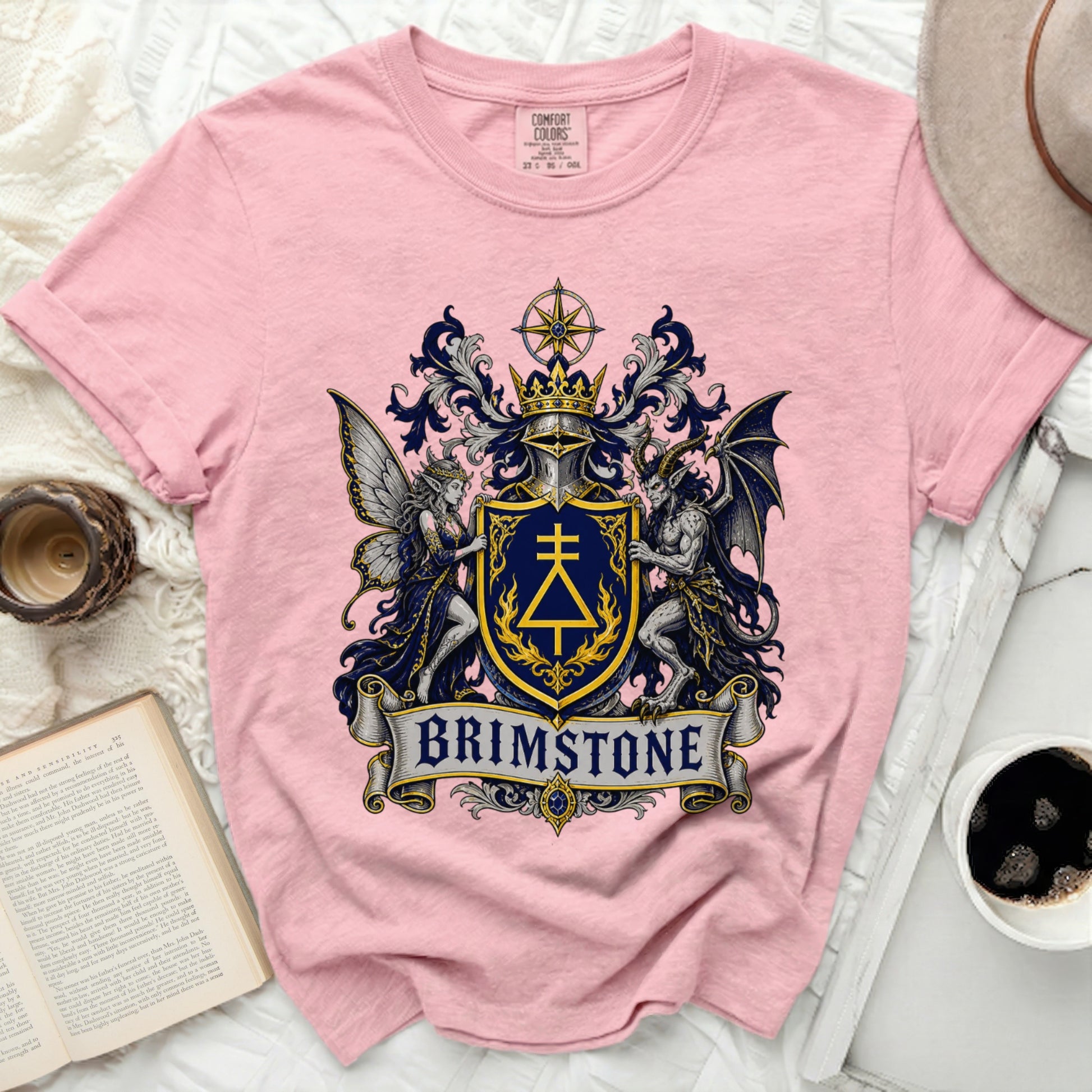 Pink t-shirt with a royal crest featuring a knight and angel, text "BRIMSTONE".