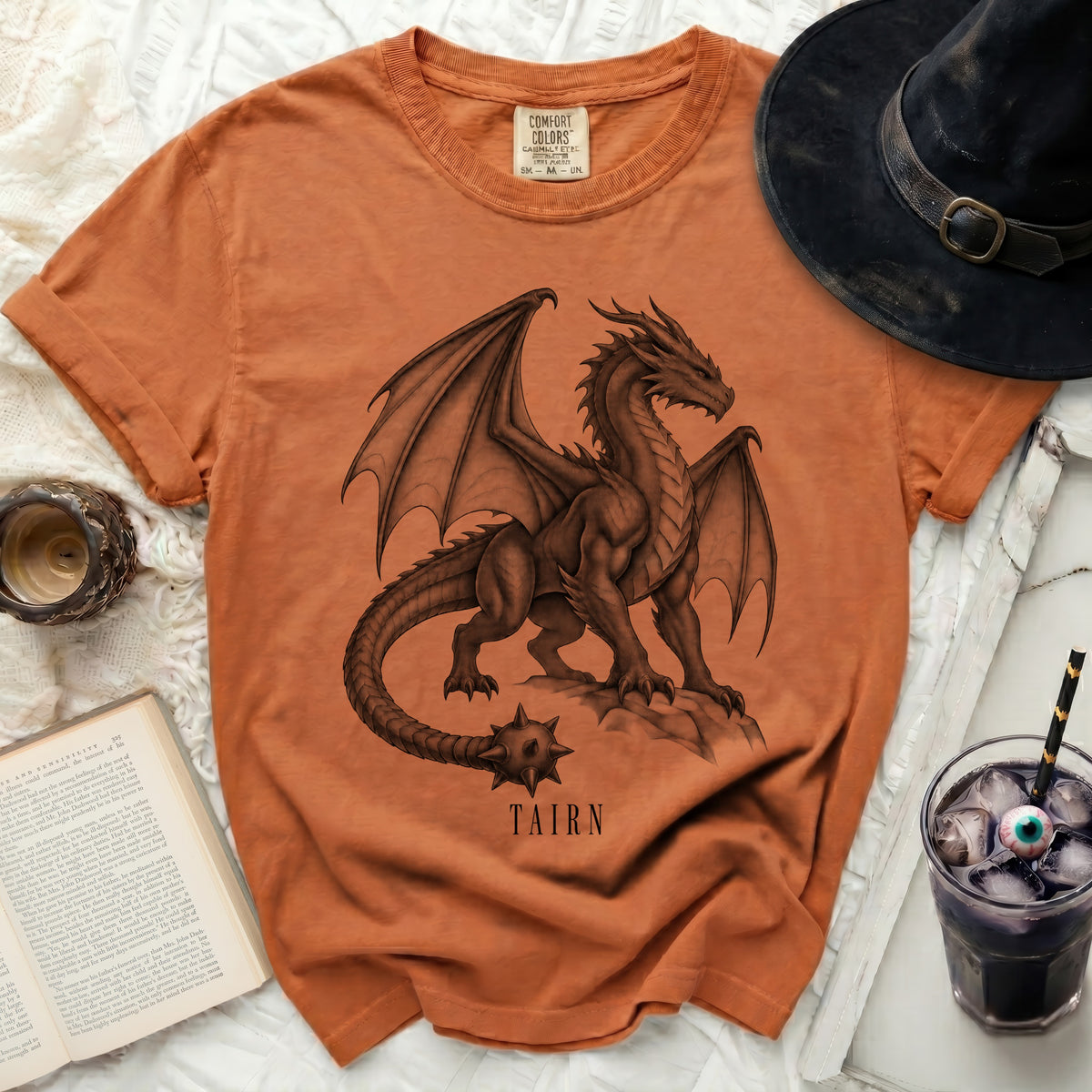 Orange t-shirt with a detailed dragon graphic and "TAIRN" text.
