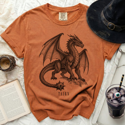 Orange t-shirt with a detailed dragon graphic and "TAIRN" text.
